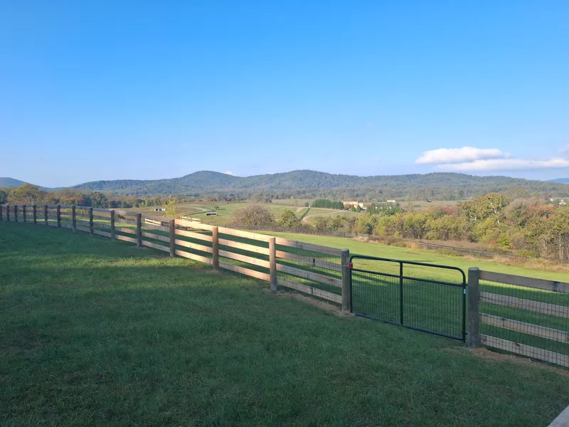 3 Board Wood Paddock Fence with Mountains in the Background
